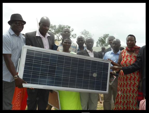 School workers carrying solar panel