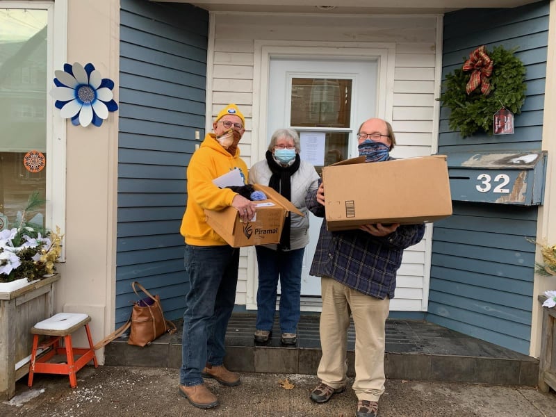 Light 4 Learning members carrying boxes of donations